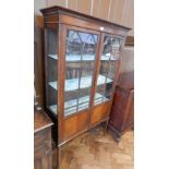 Edwardian mahogany glazed display cupboard with dental cornice,
