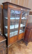 Edwardian mahogany glazed display cupboard with dental cornice,