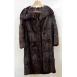 A vintage fur coat, squirrel from Rackhams, with a full cape collar, a vintage fur stole and a cream