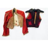Two boxes of assorted Edwardian clothes including waistcoats, many altered and adjusted for "