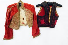 Two boxes of assorted Edwardian clothes including waistcoats, many altered and adjusted for "