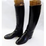 Pair of gentleman's black leather hunting boots with fitted wooded trees and back protector (