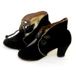 A pair of vintage black suede lace up ankle boots with stack heel