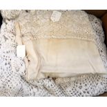 A pair of crocheted single bed covers, another in wool with a satin and lace table cover (1 box)