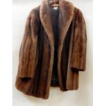 A three-quarter length mink jacket with shawl collar and bell sleeves  Live Bidding: If you would