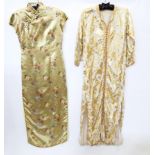 A gold-coloured satin cheongsam, full length short sleeves with frogging fastenings and a cream silk