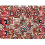 Oriental pattern wool rug with three medallions, in a pink field, floral design together with a