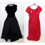 A black velvet and satin evening dress, the bodice ruched with drop waist and black velvet bows