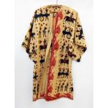 African batik robe printed with Roman type soldiers and horses in dark blues and browns on an