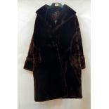 A mink jacket, shawl collar, bell sleeves with cross-banded cuff, the lining ripped and torn at