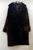 A mink jacket, shawl collar, bell sleeves with cross-banded cuff, the lining ripped and torn at