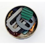 A collection of bakelite and plastic buckles and enamel buckles, etc. (1 tin)  Live Bidding: If