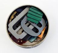 A collection of bakelite and plastic buckles and enamel buckles, etc. (1 tin)  Live Bidding: If