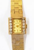 Lady's Bulova gold coloured metal and diamond set wristwatch having rectangular dial, set two rows