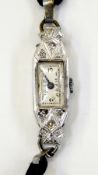 Lady's Art Deco style platinum and diamond set cocktail watch with rectangular dial, button