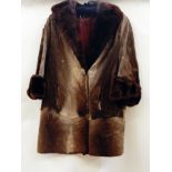 A vintage fur coat, goatskin or pony(?), trimmed with beaver collar and cuffs  Live Bidding: If