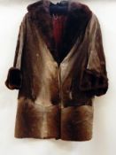 A vintage fur coat, goatskin or pony(?), trimmed with beaver collar and cuffs  Live Bidding: If