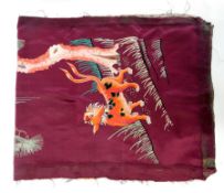 A pair of Chinese silk embroidered panels on a purple silk ground, one with tiger and eagle on a