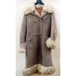 A sheepskin coat, double-breasted, with Afghan-style collar, cuffs and hem  Live Bidding: If you