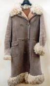 A sheepskin coat, double-breasted, with Afghan-style collar, cuffs and hem  Live Bidding: If you