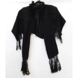 A black Victorian cape with ribbon and satin embroidered detail and lace frills  Live Bidding: If