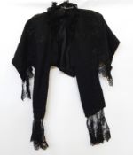 A black Victorian cape with ribbon and satin embroidered detail and lace frills  Live Bidding: If