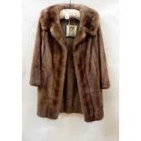 A three-quarter length mink jacket with bell sleeves  Live Bidding: If you would like a condition