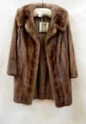 A three-quarter length mink jacket with bell sleeves  Live Bidding: If you would like a condition