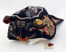 Chinese silk child's hat, embroidered with a cats face bearing a label with sealing wax stamp Live
