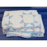 A white and blue patterned patchwork quilt backed in white  Live Bidding: If you would like a