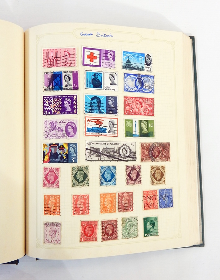 Green stamp album with collection of world stamps,