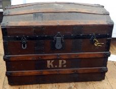 A dome-topped wooden trunk with barrel slats and leather top,