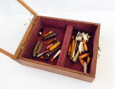 A collection of silver-mounted amber cigarette holders, carved meerschaum pipes,