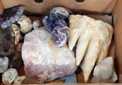 A large pink quartz stone and two pieces of smoky quartz, geodes, etc.