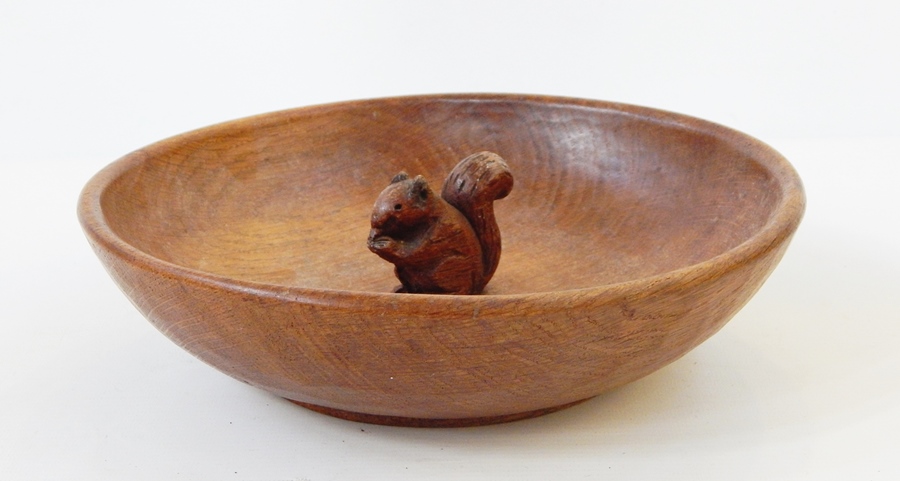 A wooden bowl in the style of Mouseman featuring a squirrel