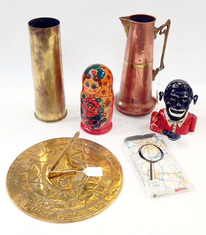 Large and small ammunition shells, a brass sundial, magnifying glass, Russian doll,