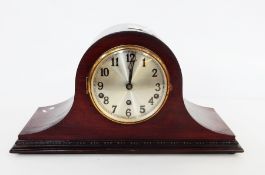 A mahogany mantel clock in Napoleon's hat-shaped case,