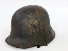A WWI German M1916 Stahlhelm with original liner and traces of camouflage paint (missing chin