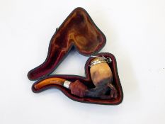Meerschaum and amber pipe in the form of lady's hand with cuff holding fly beneath the metal