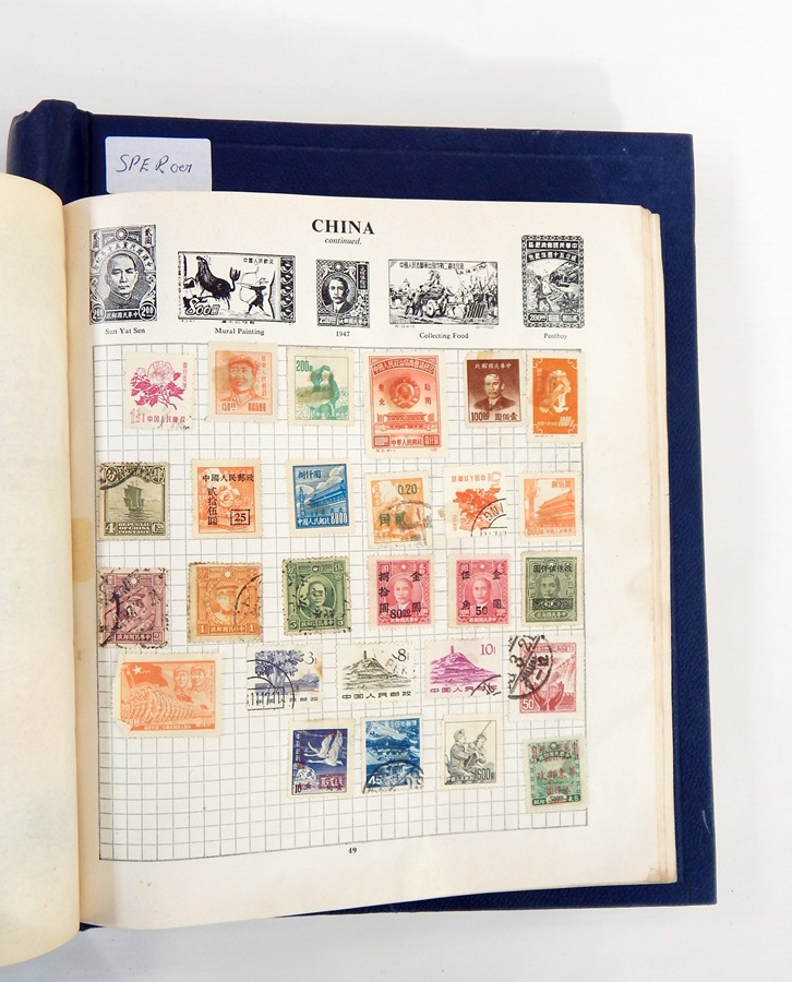 Two old blue bound stamp albums with hundreds of stamps in mixed condition,