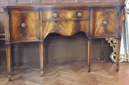 Serpentine fronted sideboard with one frieze drawer and two flanking cupboards,