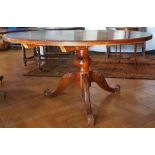 Circular oak table with tapering and bulbous supports,