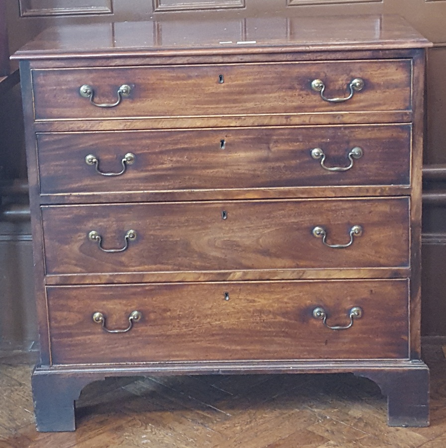 Stained oak chest of drawers with four graduating drawers, cockbead border, swan neck handles,