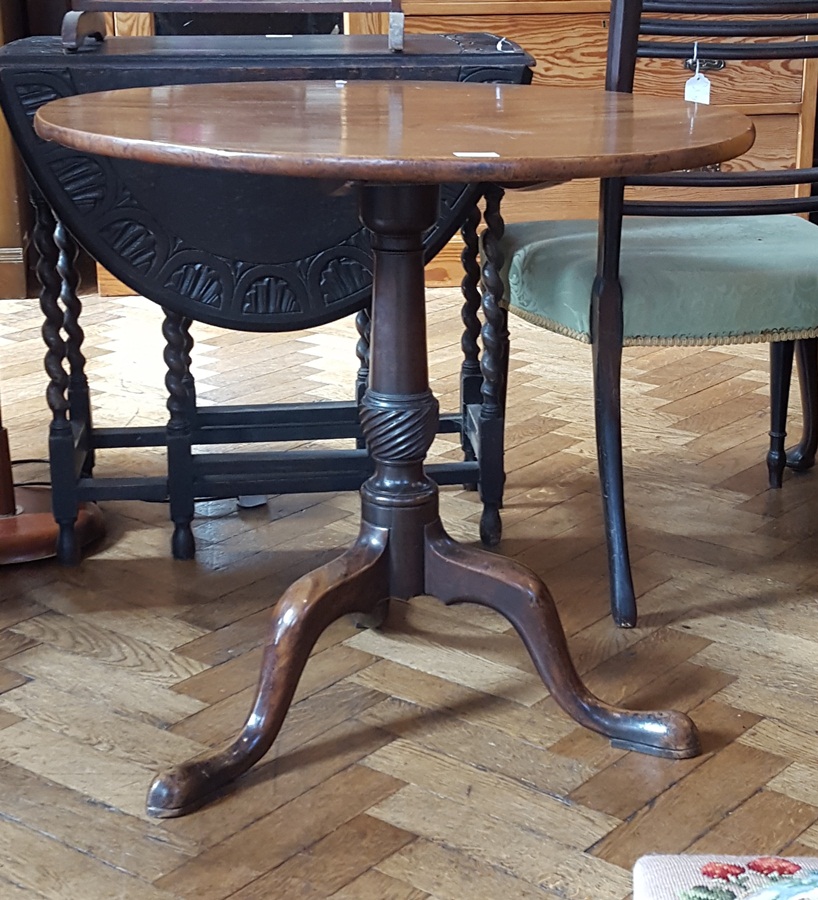 Georgian mahogany circular tilt-top tripod table on carved column support to tripod splayed legs,