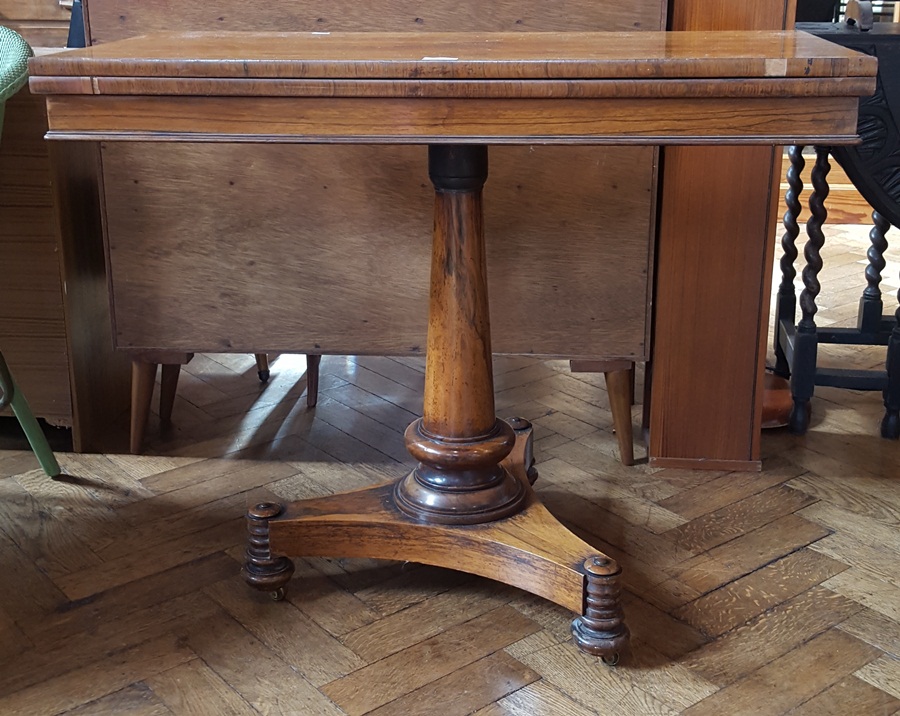 19th century rosewood foldover top card table with baize-lined interior,