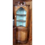 Yew and glass fronted corner cabinet with three shelves and one drawer underneath,