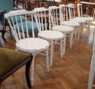 Set of six white painted stickback chairs with circular solid seats,