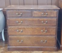 19th century oak chest of drawers of two short and three graduating drawers,