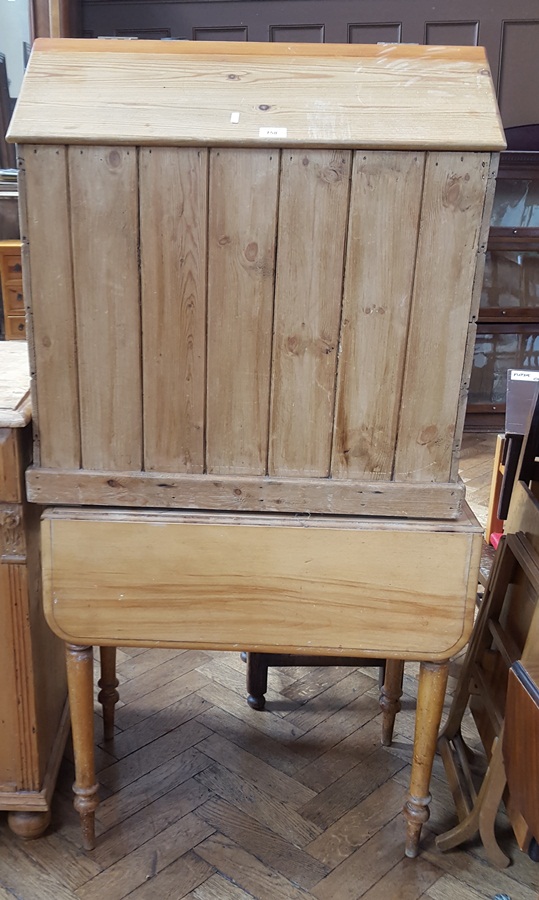 Pine storage hut with hinged sloping top together with 19th century drop-flap table on turned legs