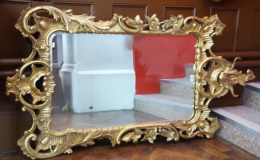 Giltwood reproduction mirror with floral and scroll decoration